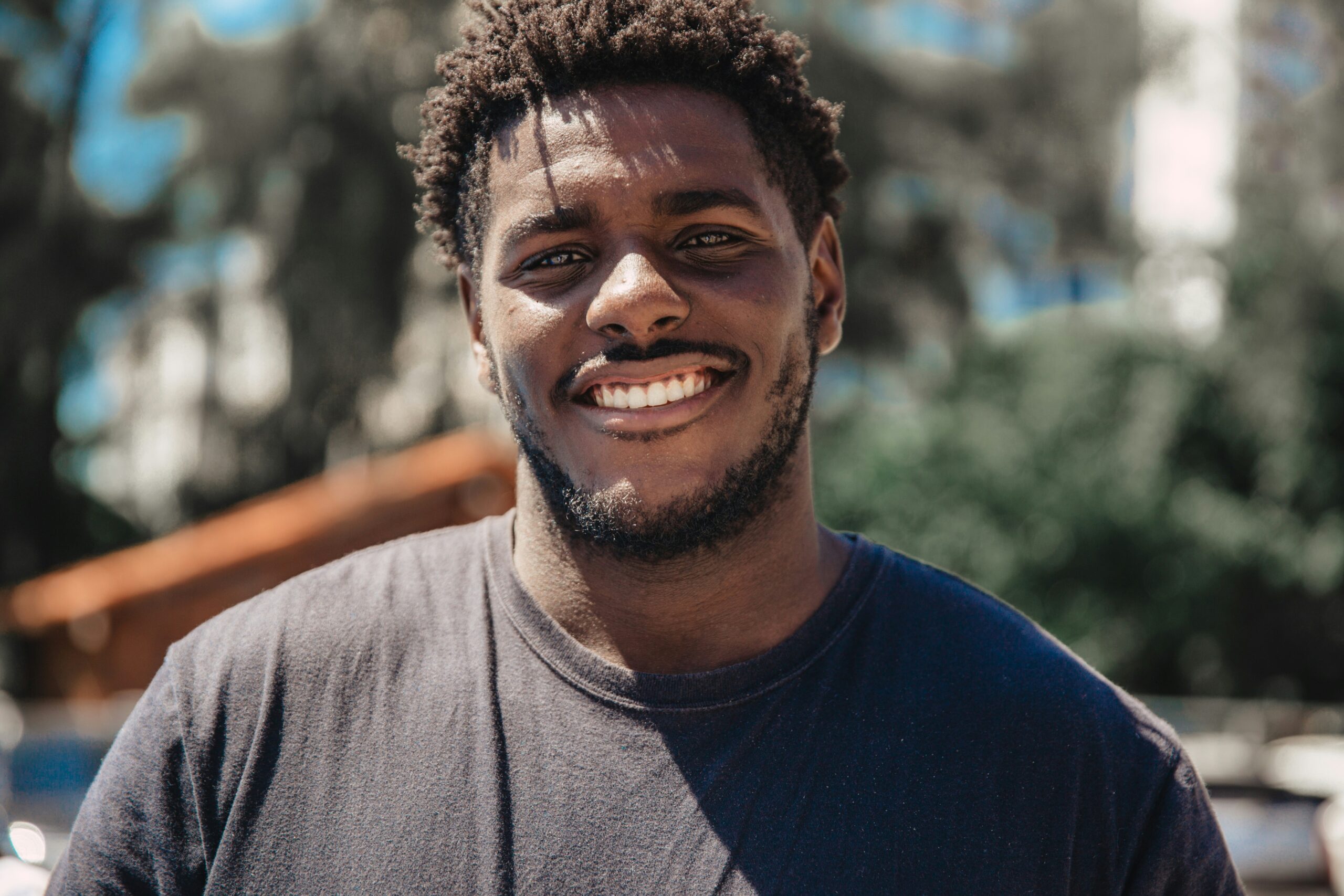 A person smiling with relief after gut-directed hypnotherapy