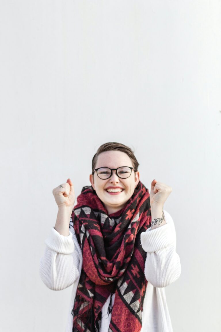 Person smiling with fists raised after a course of EAET therapy in Ontario